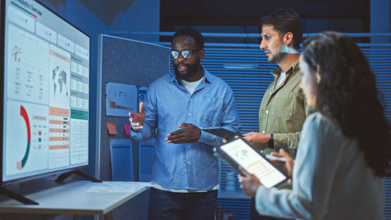 Meeting with three people looking at screen